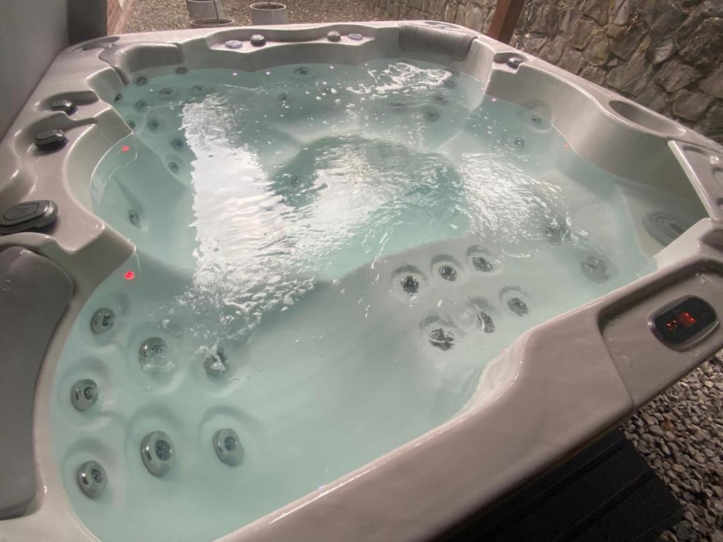 a bath tub filled with water in a sink at B&B SPA CITADELLE in Namur