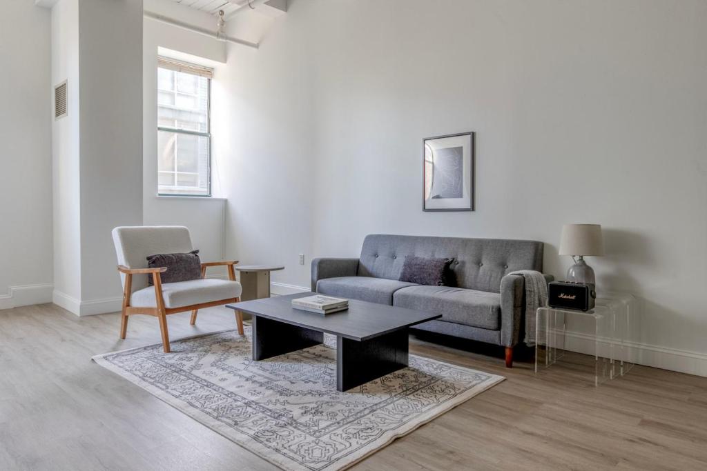 a living room with a couch and a coffee table at Central Square 2br w fitness close to dining BOS-993 in Cambridge