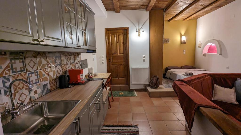 a kitchen with a sink and a bed in a room at Diminio 3 Apartment at Livadi Arachova in Arachova