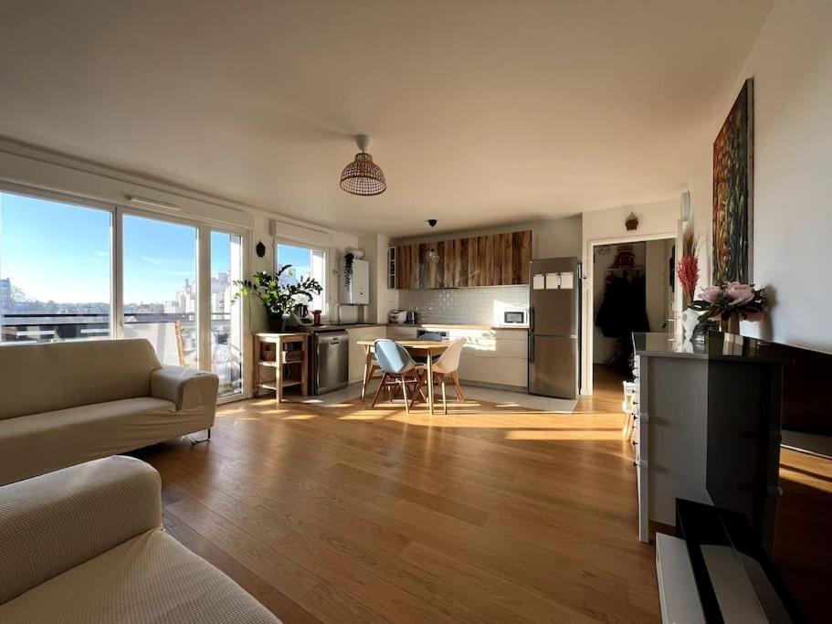 une cuisine et un salon avec un canapé et une table dans l'établissement Location for Olympic Games (JO), à Houilles