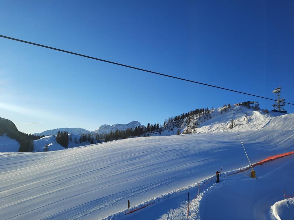 a snow covered slope with a ski lift at Almhütte Bairau Kaser in Lofer
