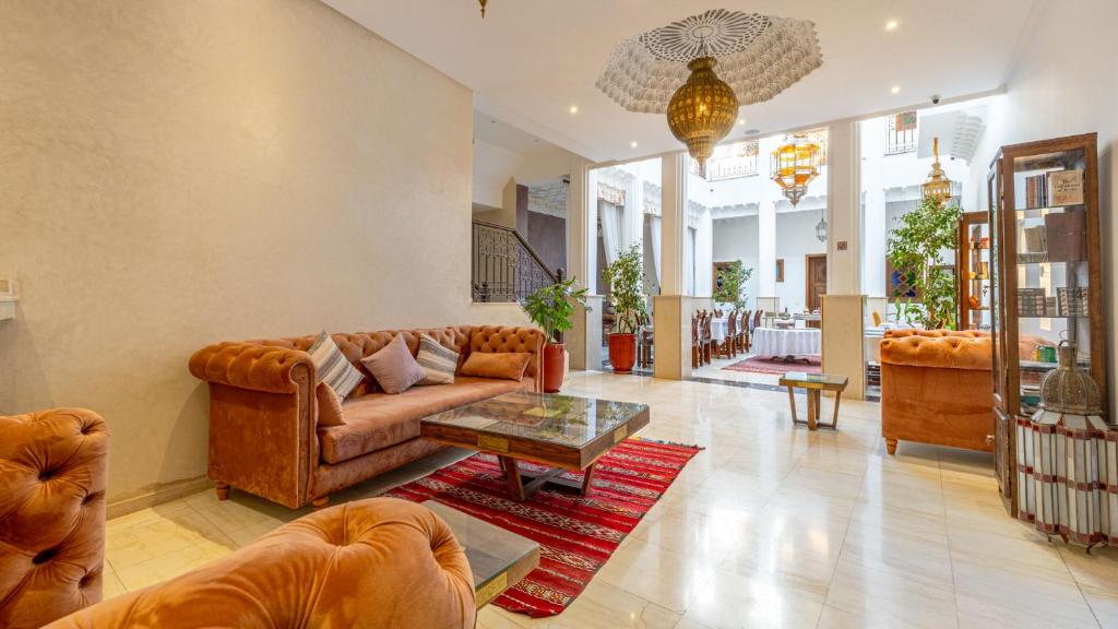 a living room with a couch and a table at Riad Mandana & Spa in Marrakesh