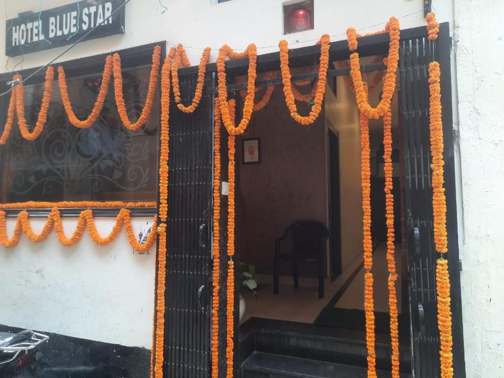 an entrance to a building with orange garland at New hotel blue stars in Varanasi
