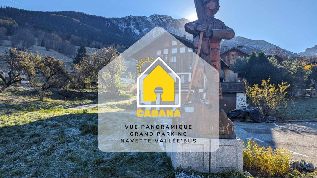 a sign in front of a building with a mountain in the background at Cabana & Les Débuts du Ski in Les Avanchers