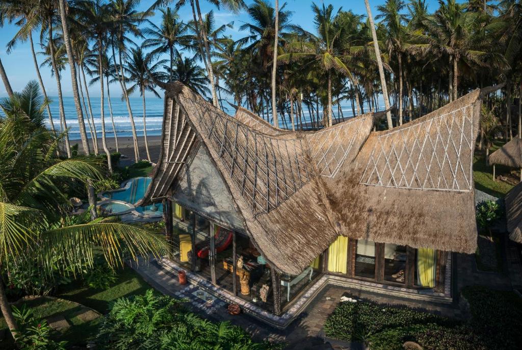an aerial view of a resort with palm trees at Beachfront Villa Laut Tabanan in Tabanan