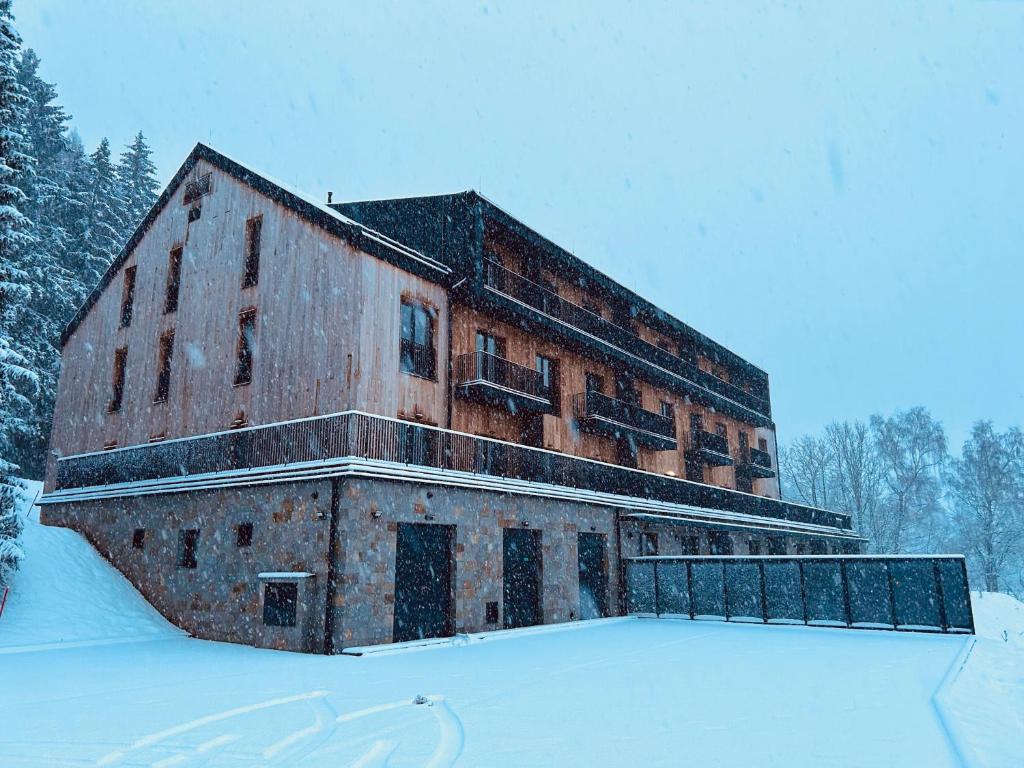 an old brick building with snow on the ground at Benecko - apartmán s výhledem in Benecko
