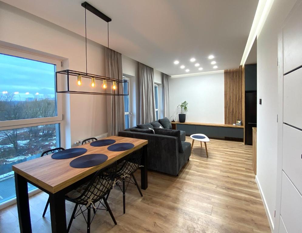 sala de estar con mesa y sofá en Panorama Zamkowe 6, en Rzeszów