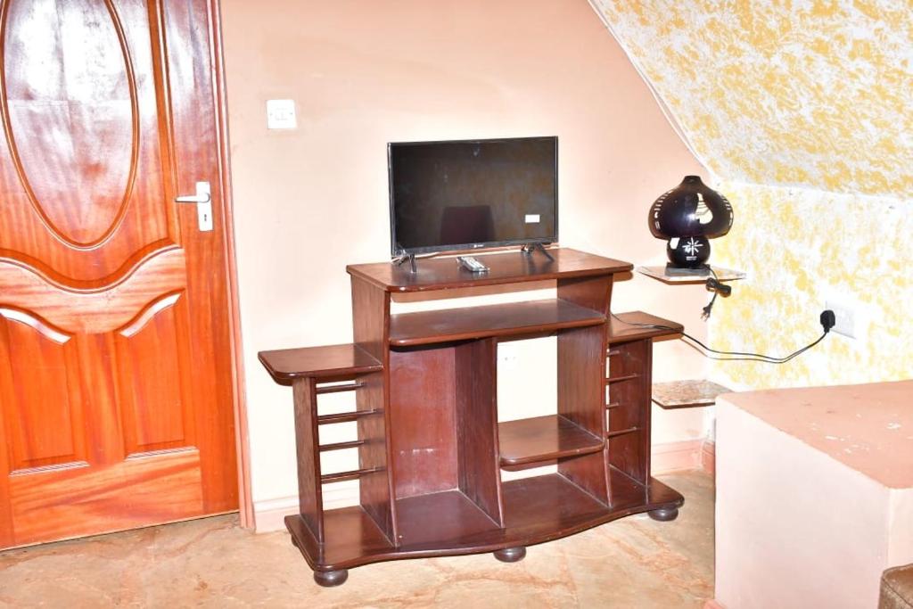 a wooden desk with a television on top of it at Airman’s Lodge 