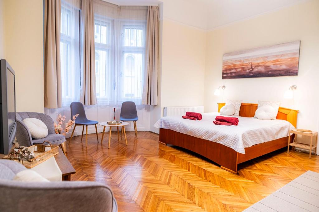 ブダペストにあるアパートメント チャールズのベッドルーム1室(ベッド1台付)、リビングルームが備わります。