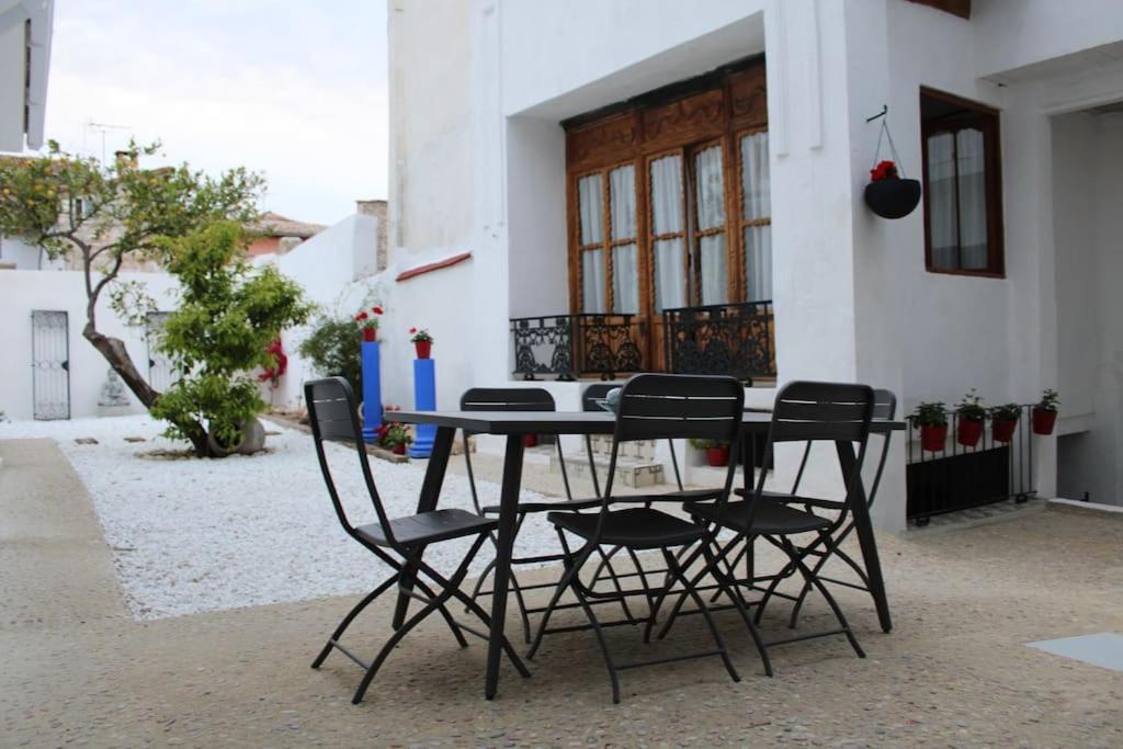 a table and four chairs in front of a house at Les Portes in Xàtiva