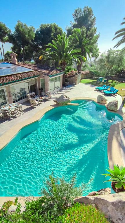 a swimming pool with blue water in a yard at Azzurra Home-Charming Property- For 6 guests in Benissa
