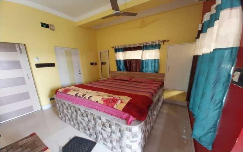 a bedroom with a large bed in a room at Home stay world in Bolpur