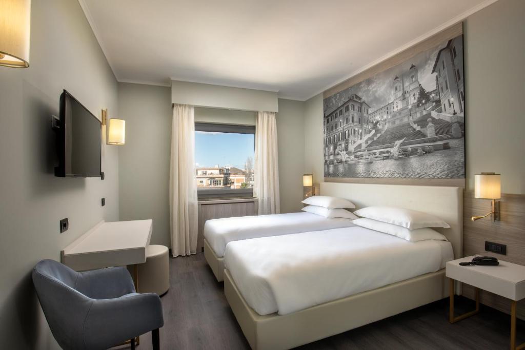 Postel nebo postele na pokoji v ubytování Hotel Marc'Aurelio