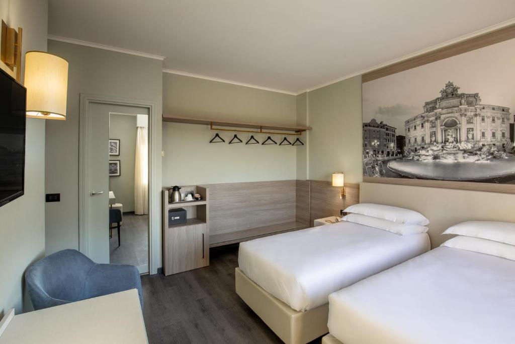 Postel nebo postele na pokoji v ubytování Hotel Marc'Aurelio