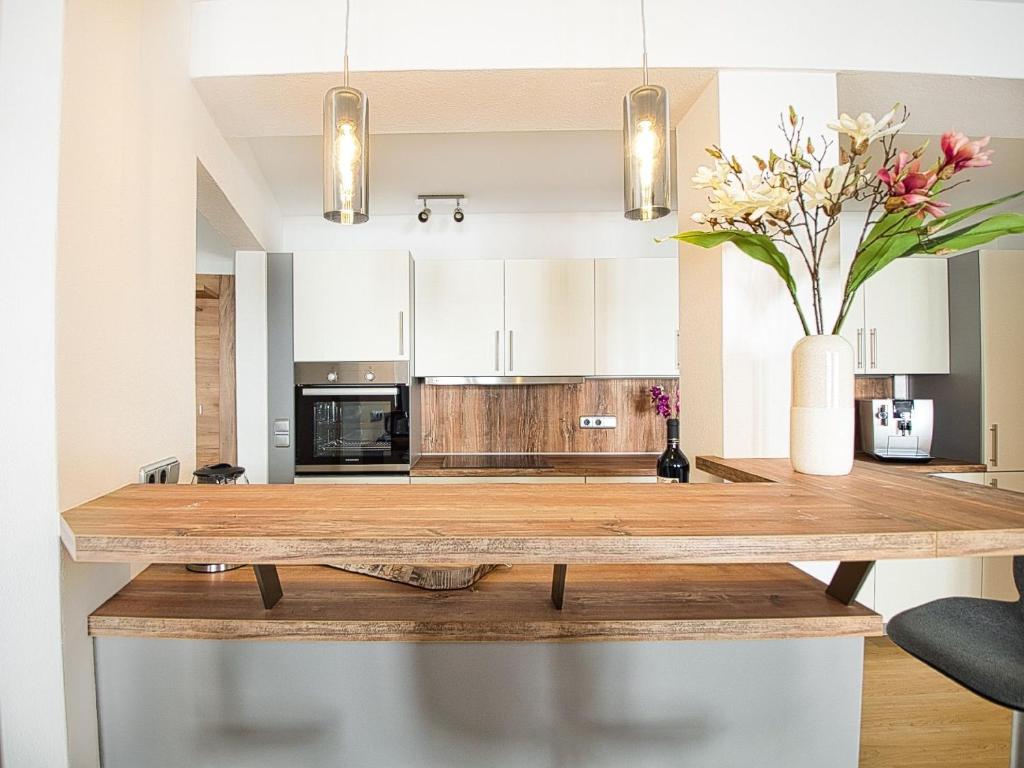 a kitchen with a wooden counter with a vase of flowers at Ferienwohnung Bergliebe in Berchtesgaden