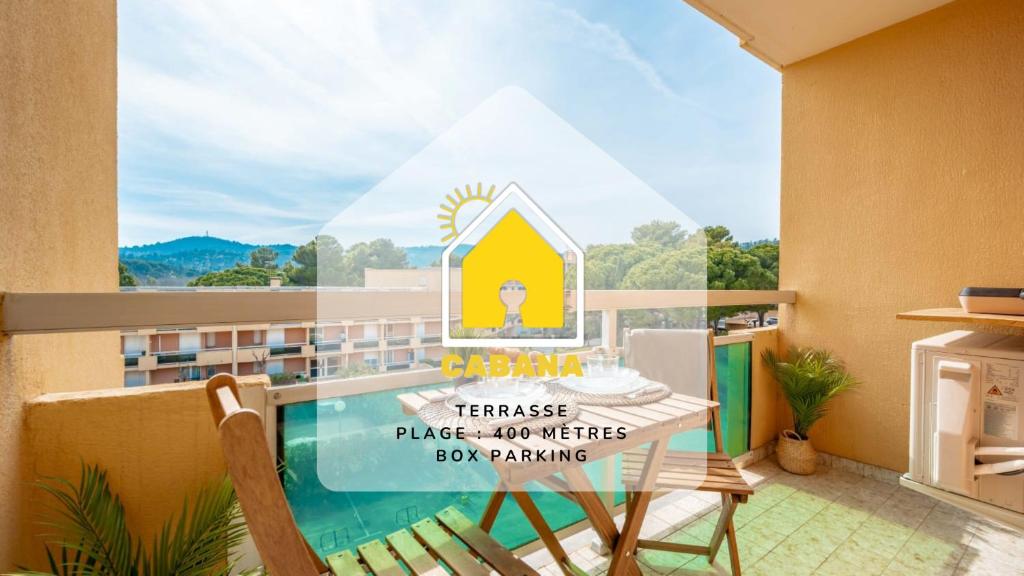 a balcony with a table and chairs and a swimming pool at Cabana & Le Mimosa Ensoleillé - Plage, Box, Terrasse in Bormes-les-Mimosas