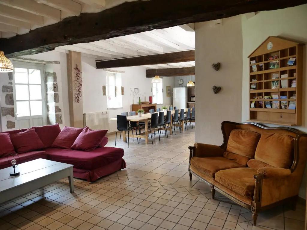 a living room with a couch and a table at Sous le même ciel in Contigny