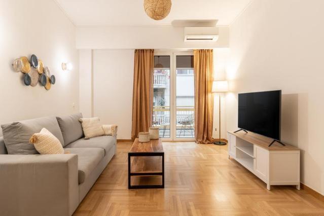 a living room with a couch and a flat screen tv at Apartment in Historic Athens city centre in Athens
