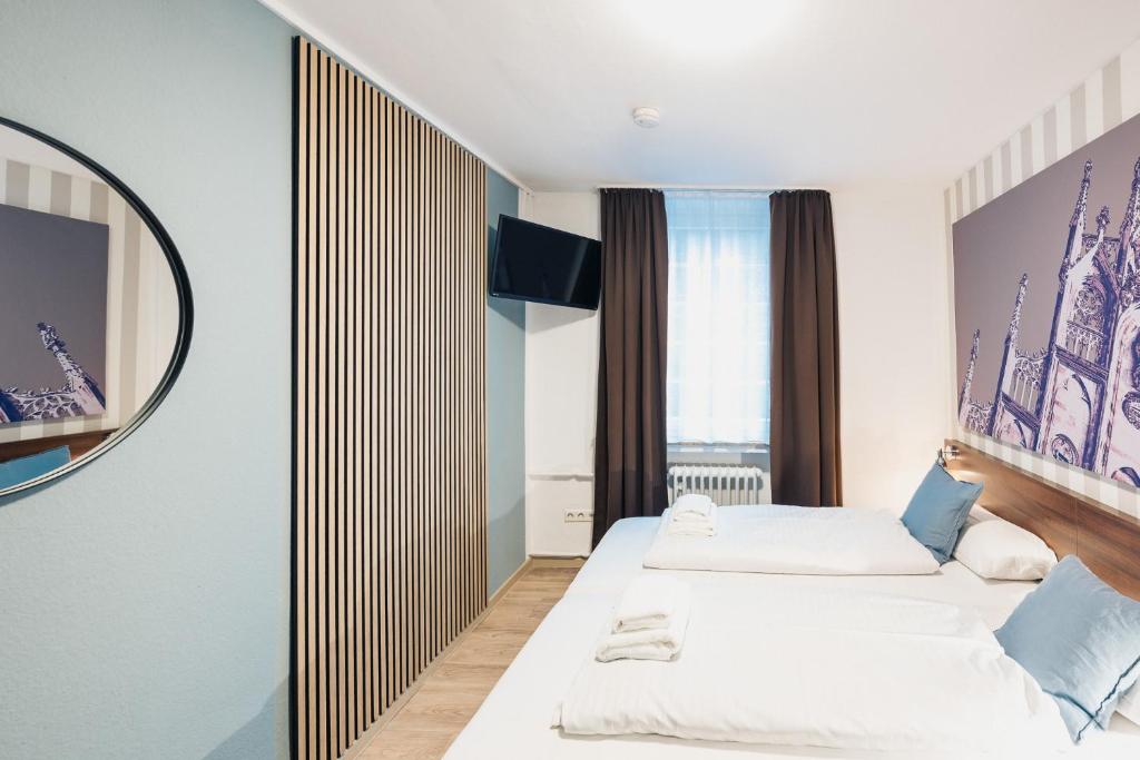 Postel nebo postele na pokoji v ubytování Hotel Busche am Dom