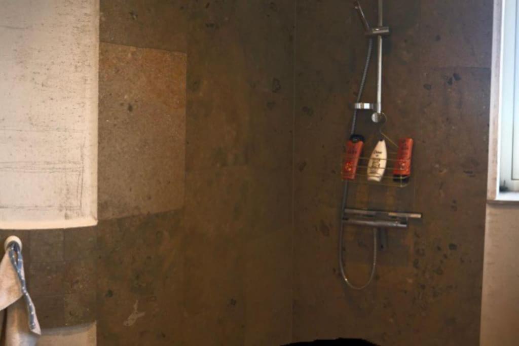 a bathroom with a shower with a shower head at Luxurious design villa near beach - sleeps 8+ in Klintehamn