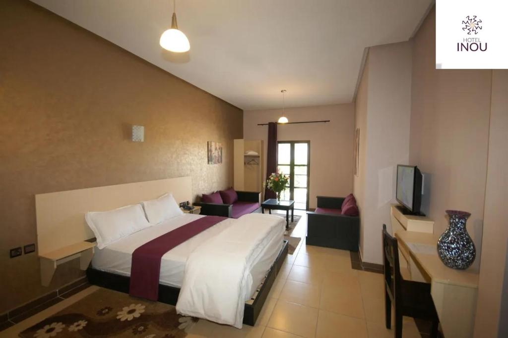 Postel nebo postele na pokoji v ubytování INOU Hotel