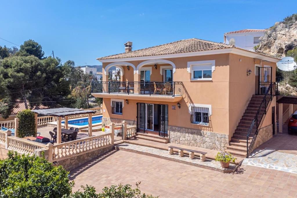 a large house with a balcony and a patio at Villa Dos Perlas in Alicante