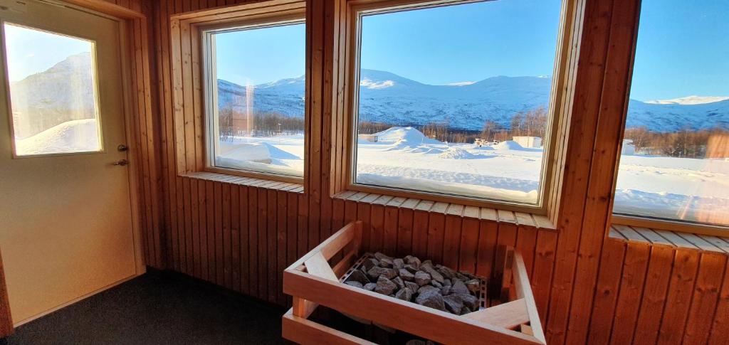 a room with two windows and a pile of rocks at Umfors Camping in Umasjö