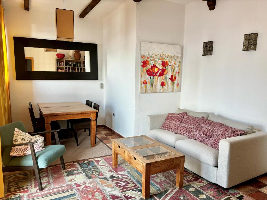 a living room with a couch and a table at Barceloneta Ramblas Apartments in Barcelona