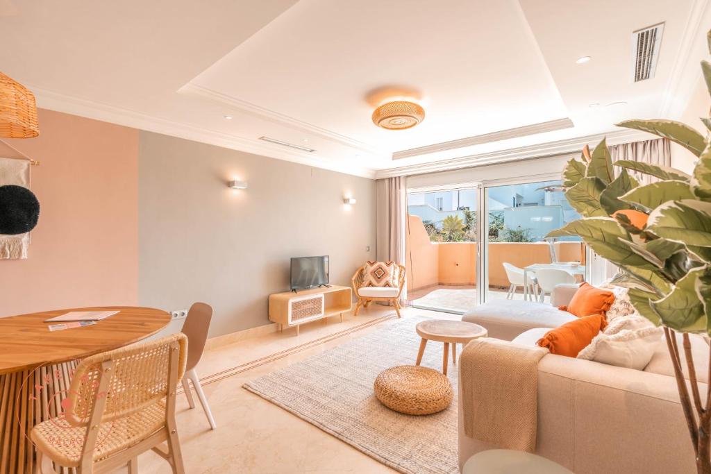 a living room with a couch and a table at Stylish Apartment Aloha Hill Club Marbella - TCM in Marbella