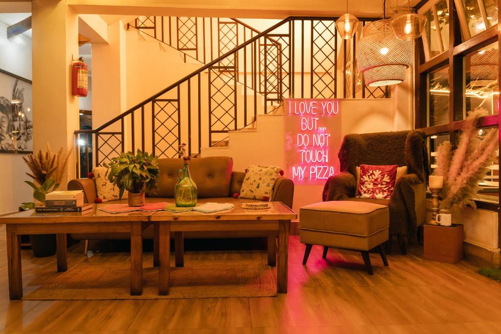 a room with a table and a chair and a staircase at The Living Roof in Shillong