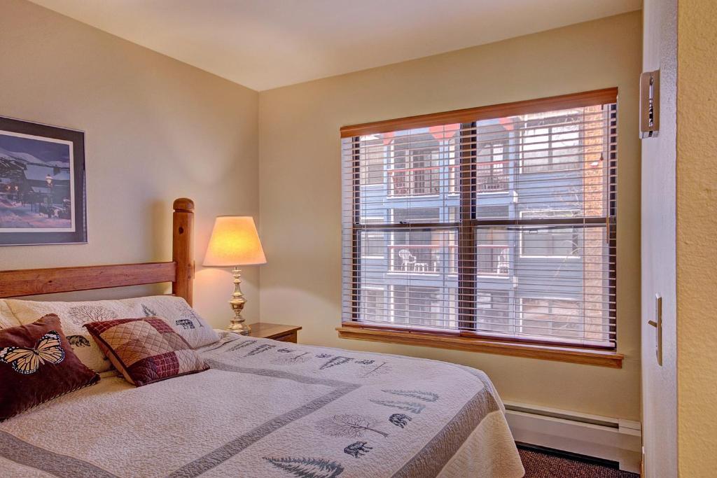 a bedroom with a bed and a large window at River Mountain Lodge by Breckenridge Hospitality in Breckenridge