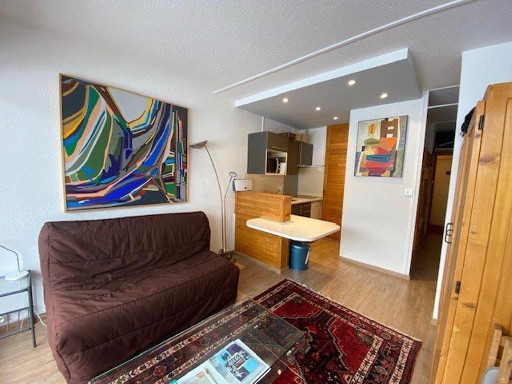 a living room with a couch and a kitchen at Studio Arette, 1 pièce, 4 personnes - FR-1-602-115 in Arette