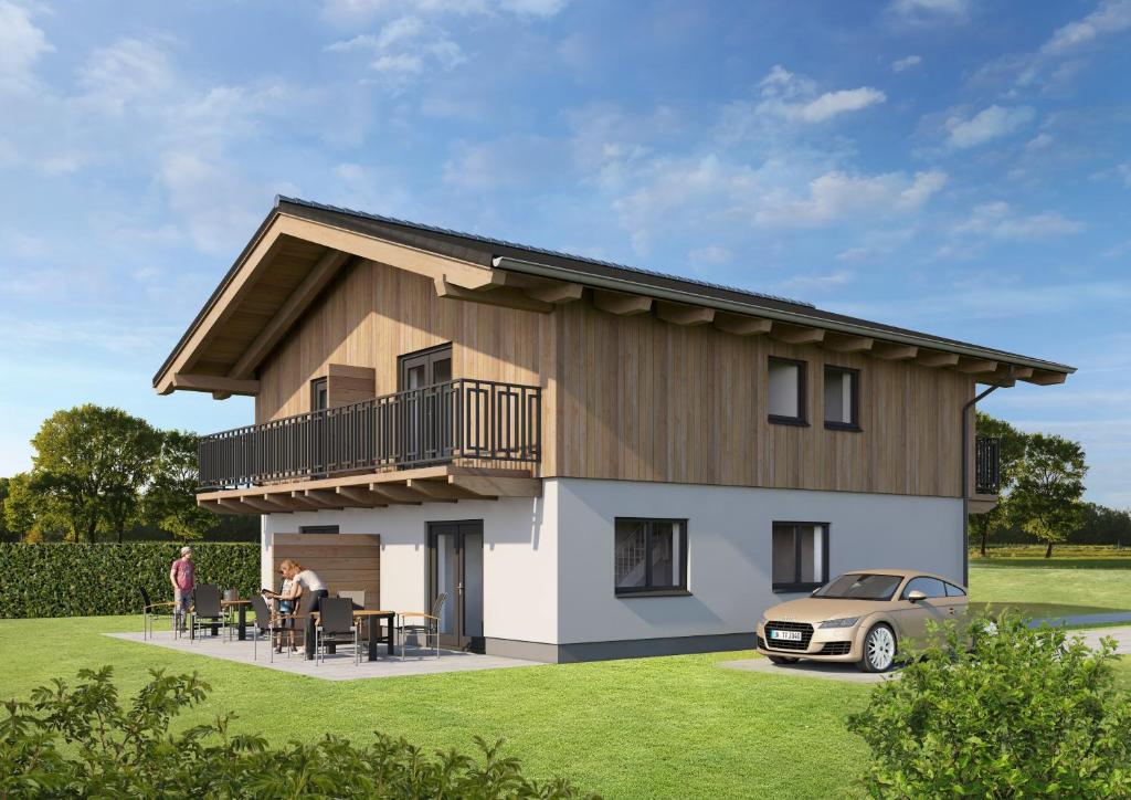 a house with a car parked in front of it at Clofers Nature Chalets Obermöschach in Hermagor