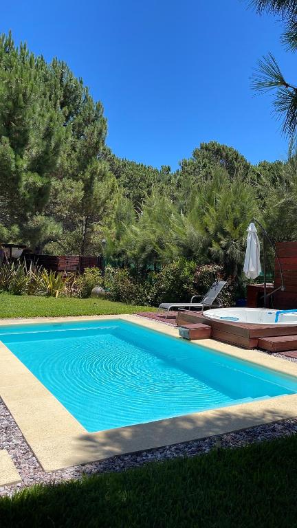 a swimming pool in the yard of a house at Studio en Chihuahua in Punta del Este