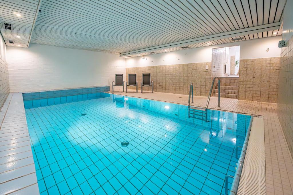 a large swimming pool with blue tiles on the floor at Sylter Krabbe in Westerland
