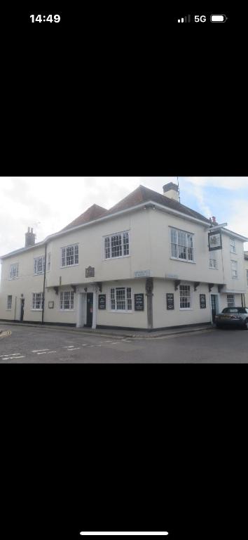 a white building with a car parked in front of it at Kings Arms Hotel in Sandwich