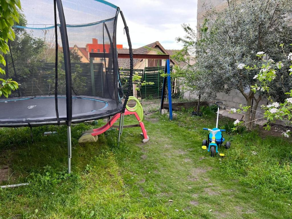 a playground with a trampoline and a swing set at 2Appartement dans un pavillon ac vue sur le jardin in Argenteuil