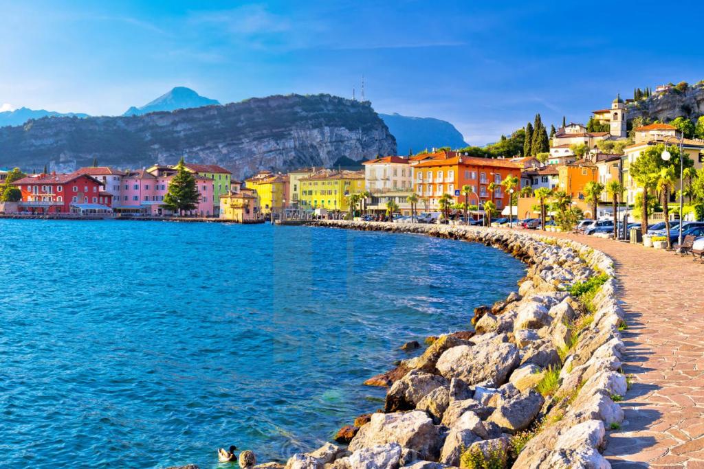 a view of a town next to the water at ApartmentsGarda - Residence Pasola in Brenzone sul Garda