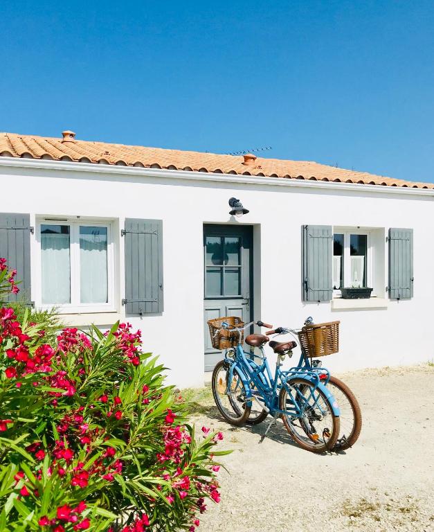 deux vélos garés devant une maison dans l'établissement Boinot Lodge, au Château-dʼOléron