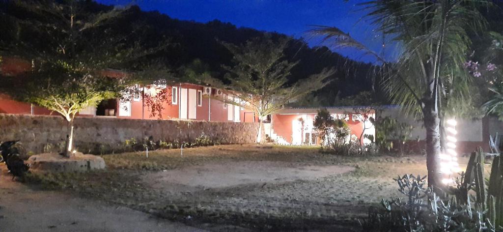 a red building with trees in front of it at Spazio Hotel in Karimunjawa