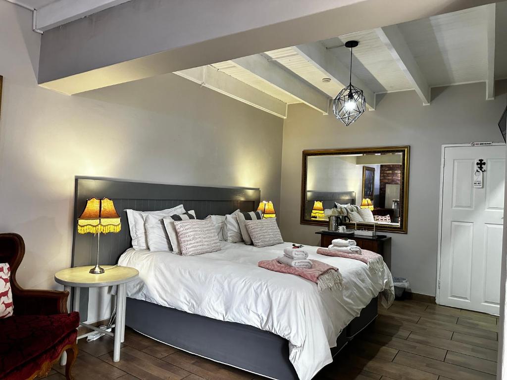a bedroom with a large bed and a mirror at 59 On True North Guest in Johannesburg
