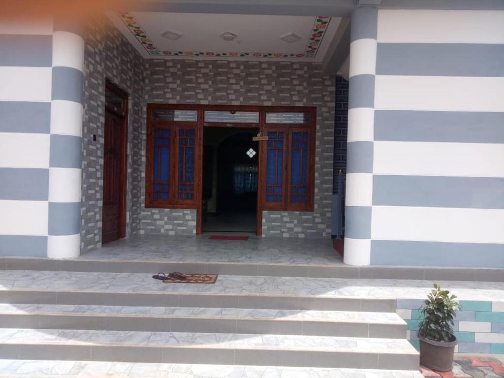 a front door of a building with blue and white stripes at Billiards villa in Trincomalee