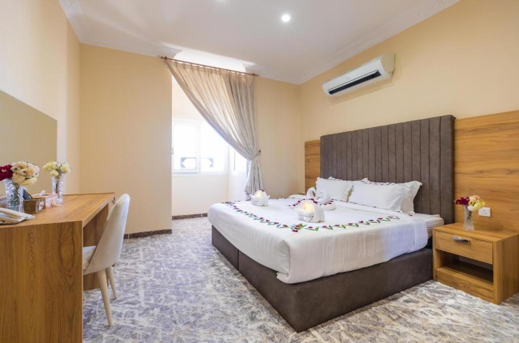 Habitación de hotel con cama grande y escritorio. en Lavent Park Hotel Suites en Yeda