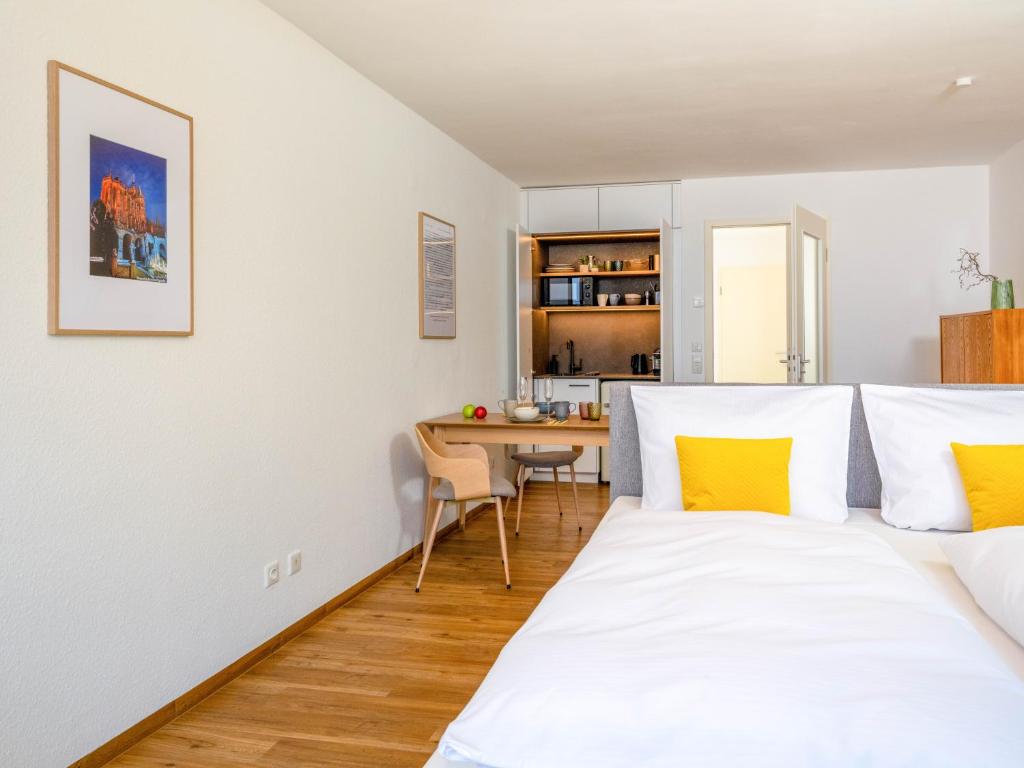 a bedroom with two beds and a dining room with a table at Altstadt Apartment for 2 in Erfurt