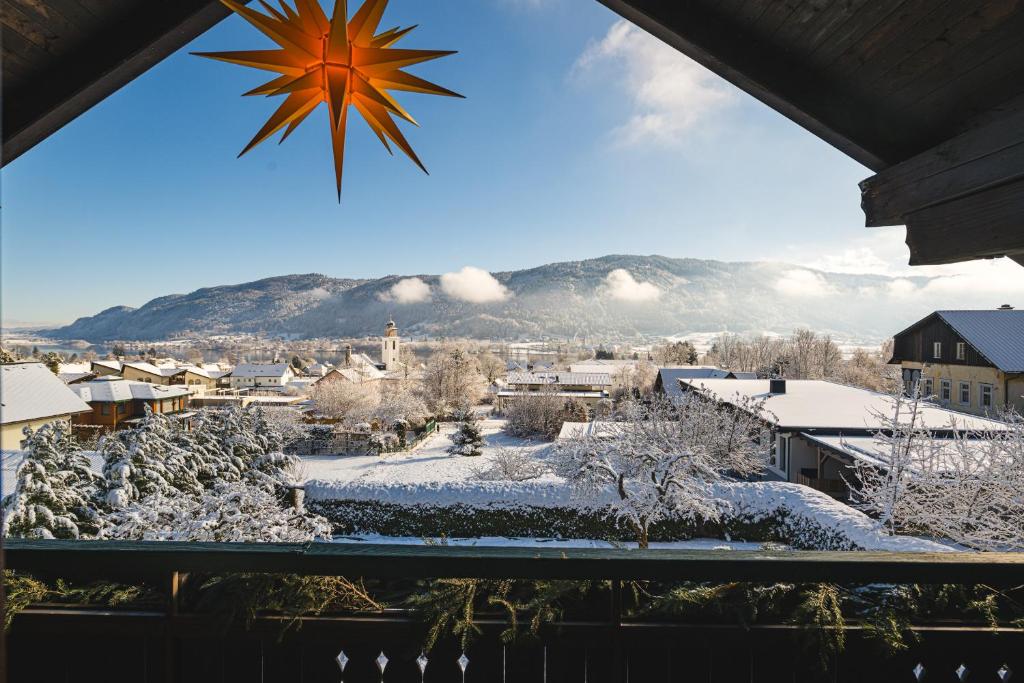 a winter view of a town with snow on the ground at Landhaus BERGSEE in Bodensdorf