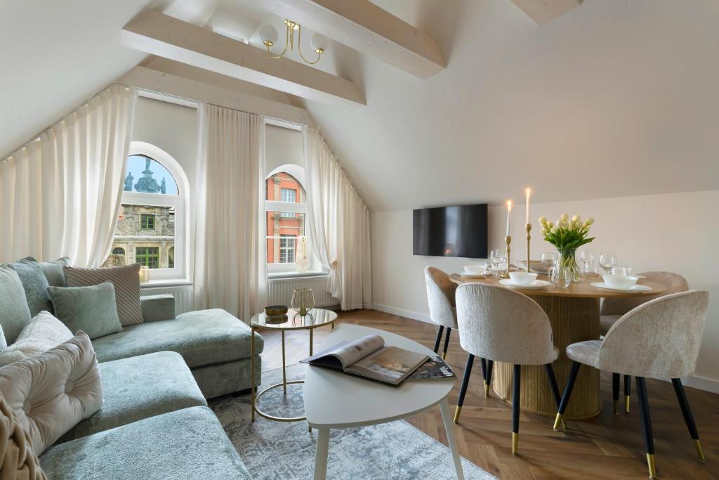 a living room with a couch and a table at Elite Apartments Długa Prestige in Gdańsk