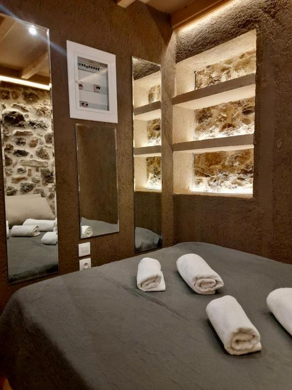 a bedroom with a bed with two white towels on it at D&P Cell Oneiro. in Kalavrita