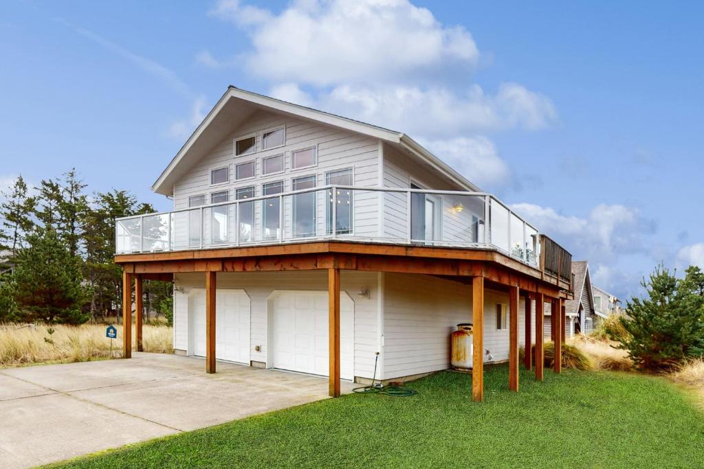 a large white house with a balcony on it at The Capella in Pacific City