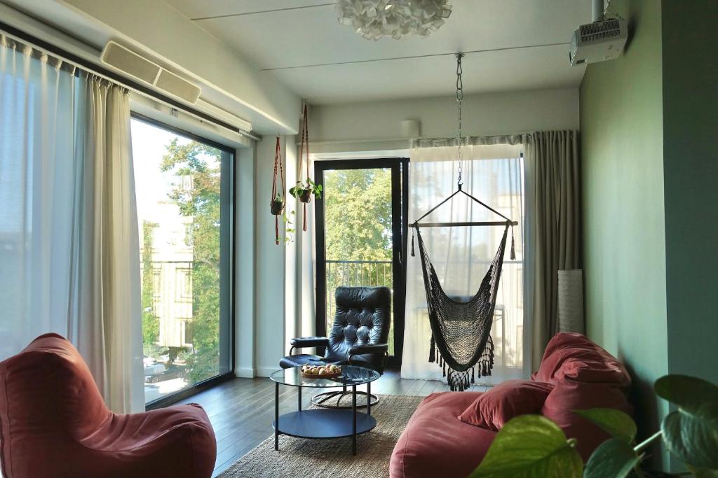 a living room with a couch and a hammock at Cozy 2BR Apartment in Kalamaja + rooftop terrace in Tallinn