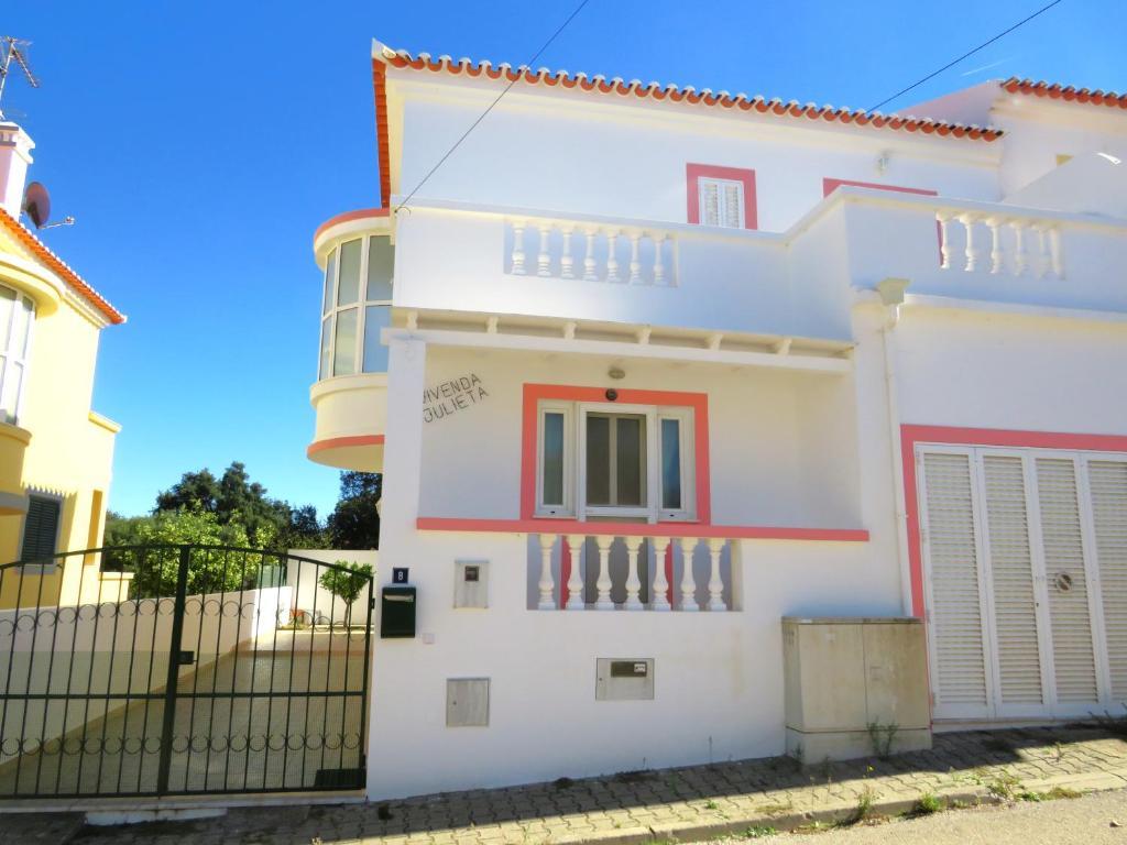 a white house with red accents at Casa Julieta in Altura